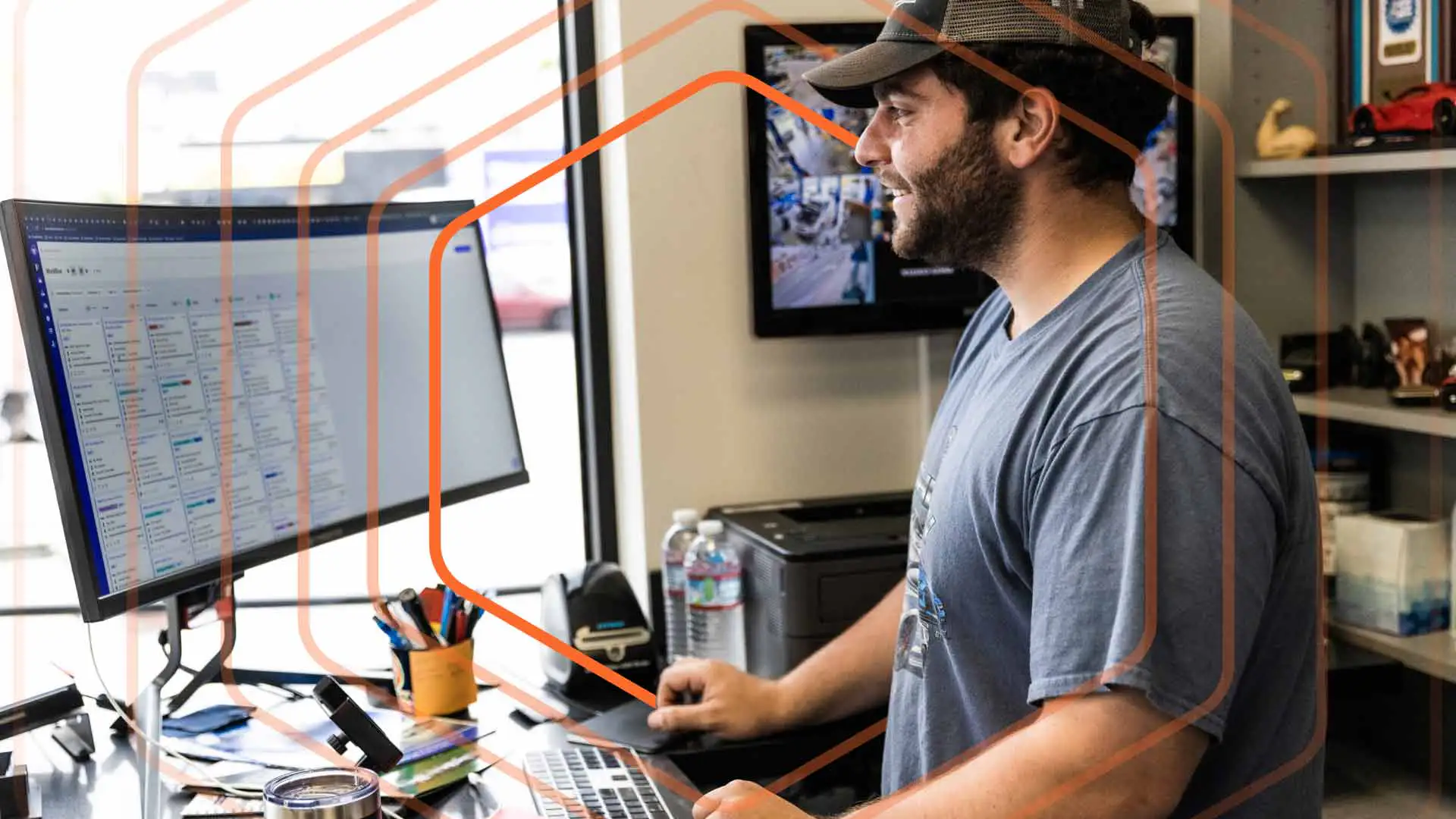 Man with hat and beard working on a desktop with Shopmonkey.