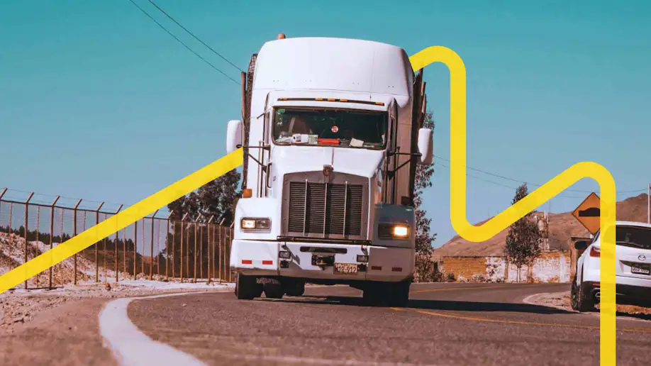 A semi-truck traveling down a road.