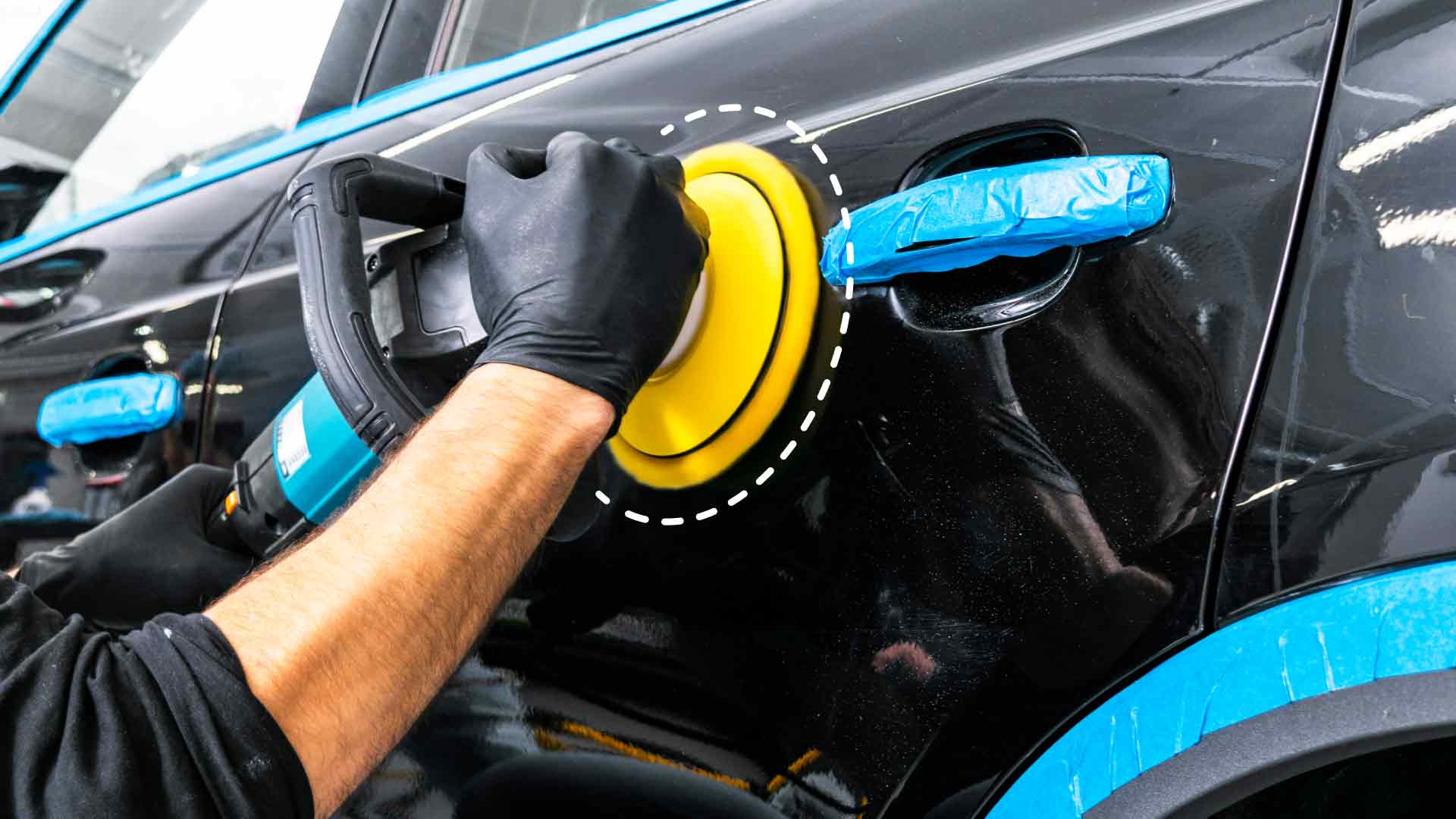 An auto detailer sanding a vehicle's paint.