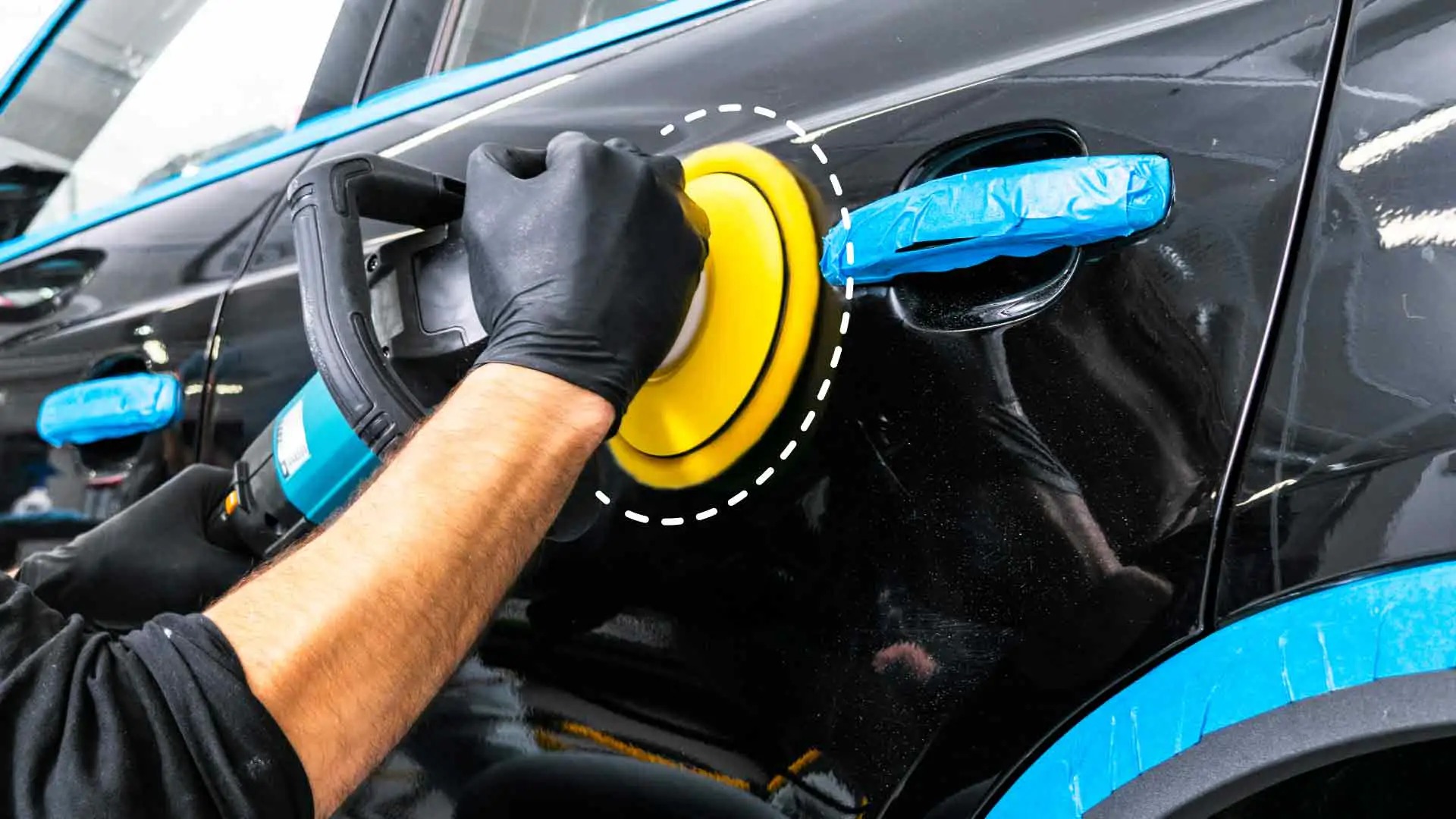 An auto detailer sanding a vehicle's paint.