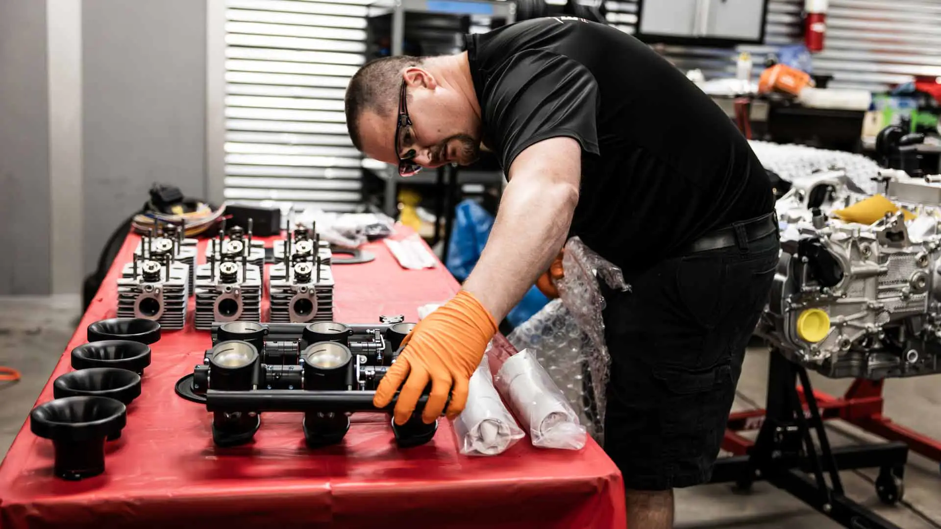 An auto technician inspecting auto parts.