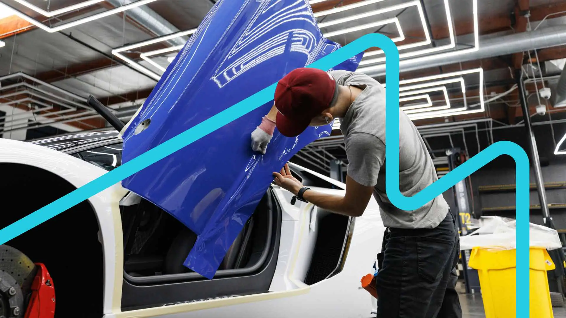 An auto technician applying paint protection to a vehicle.