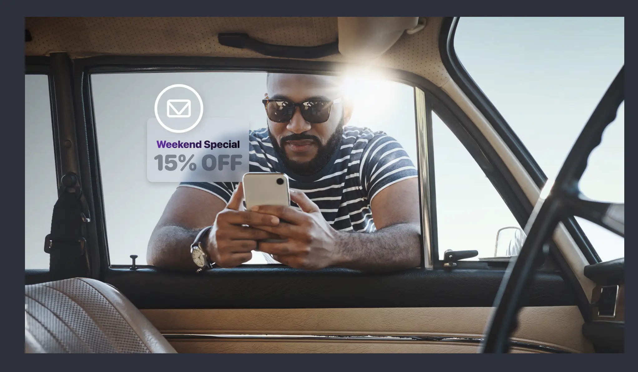 A happy auto shop customer receiving a weekend discount offer via email.