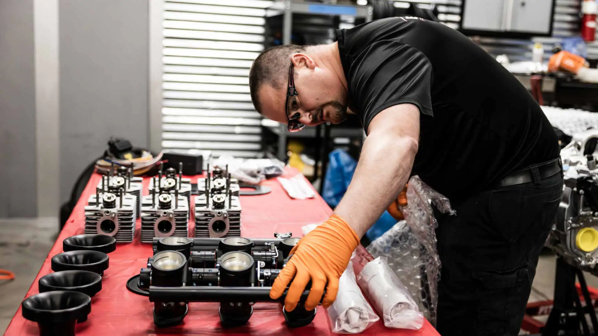 An auto repair technician inspecting auto parts.