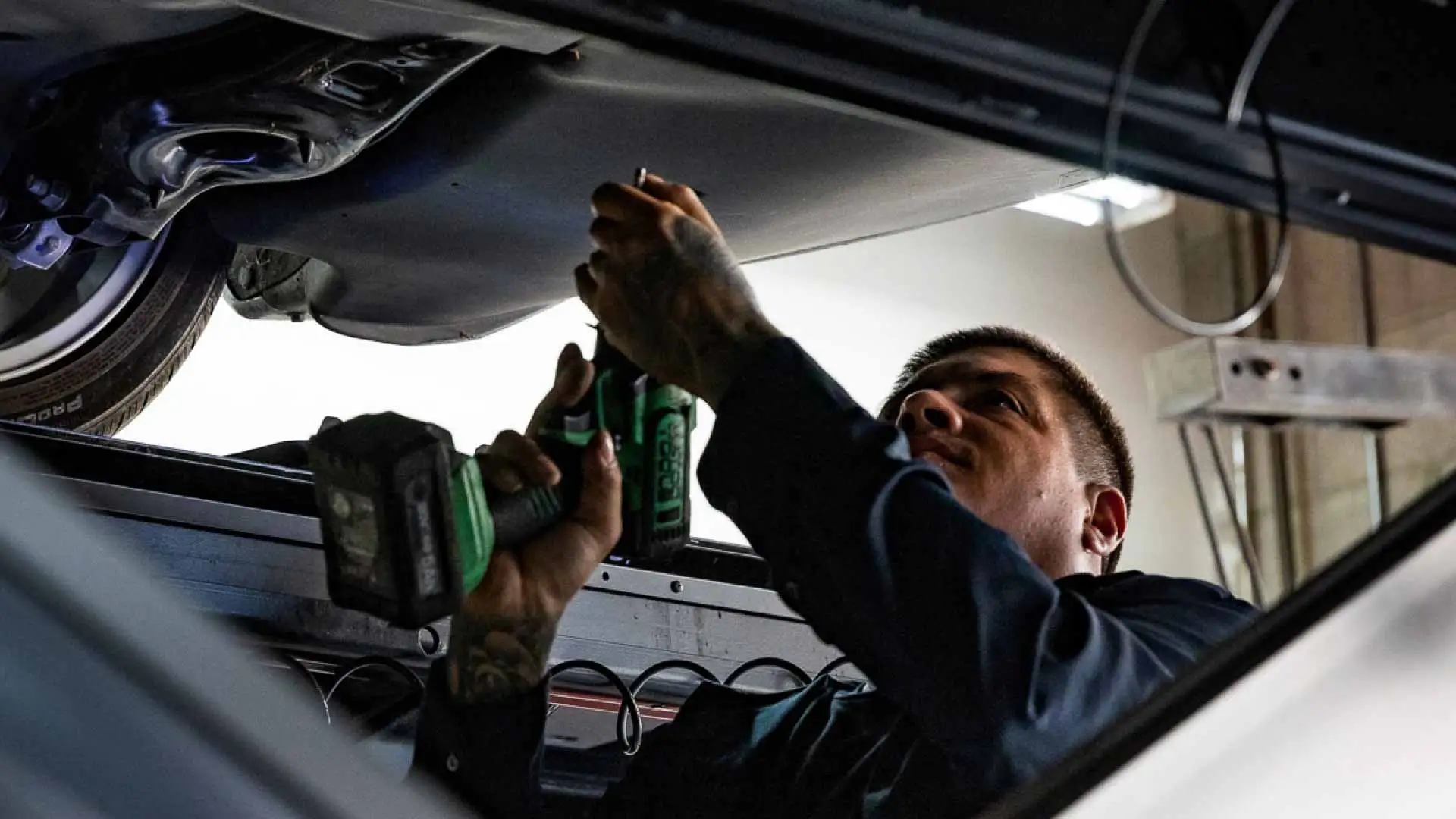 An auto technician working on a vehicle.