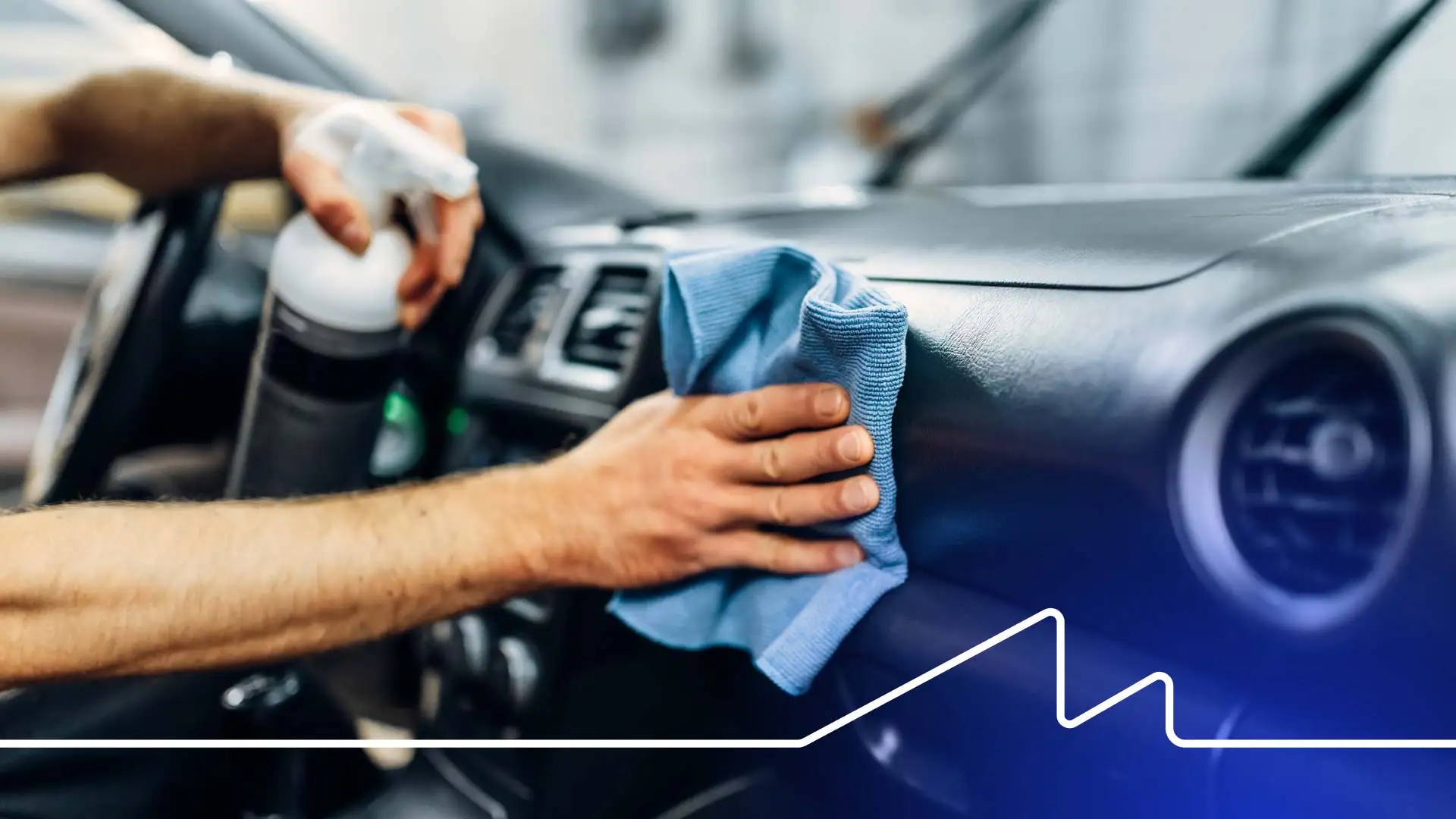 An auto detailer cleaning the interior of a vehicle.