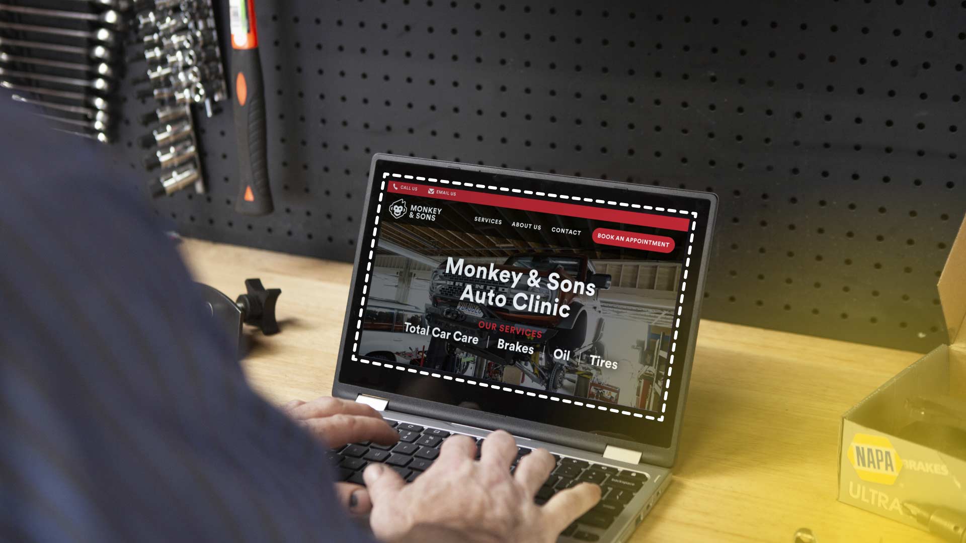 An auto shop owner working on his website.