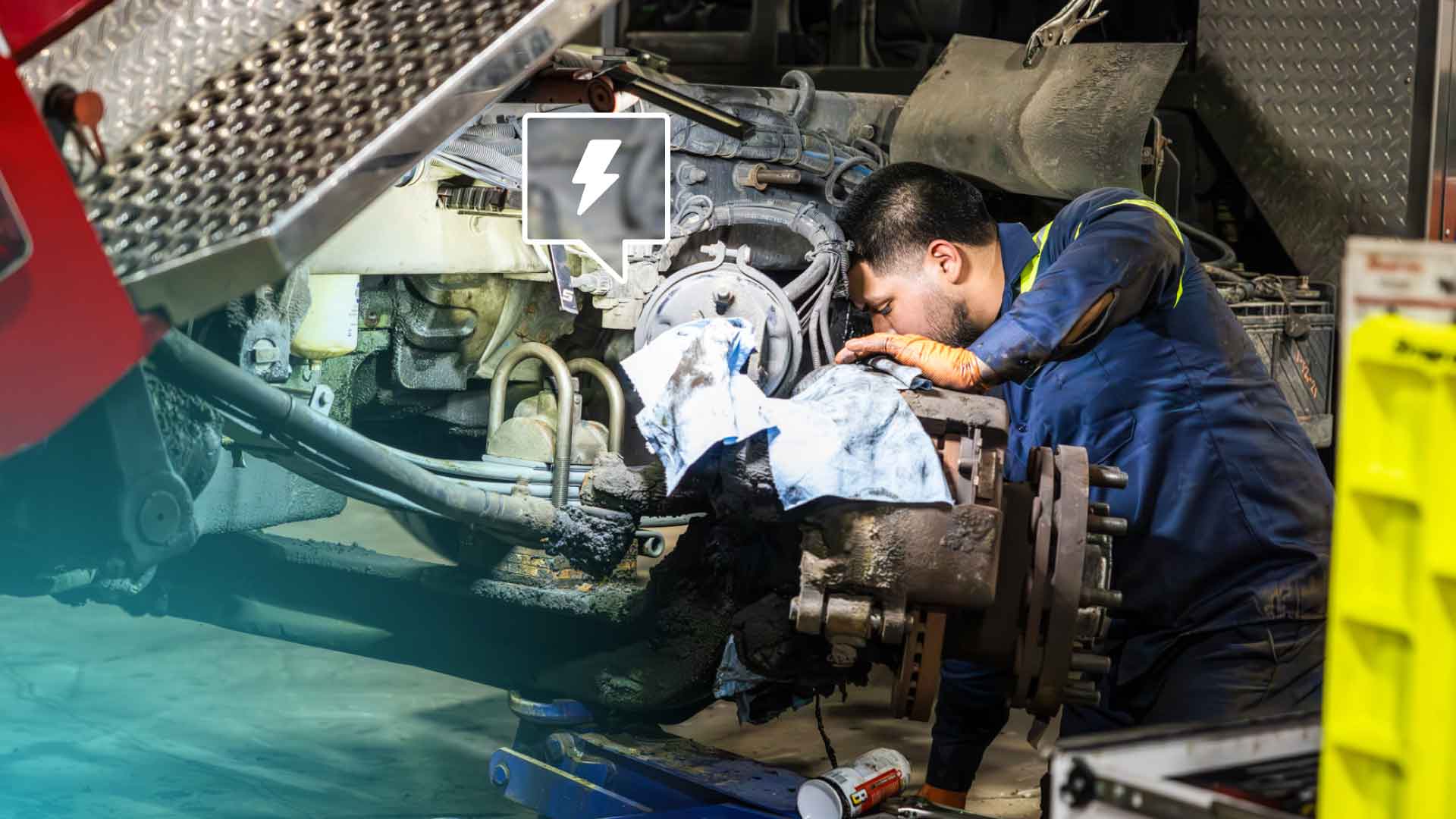 A diesel repair technician working on a truck engine.