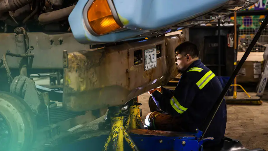 A professional mechanic repairing a truck.