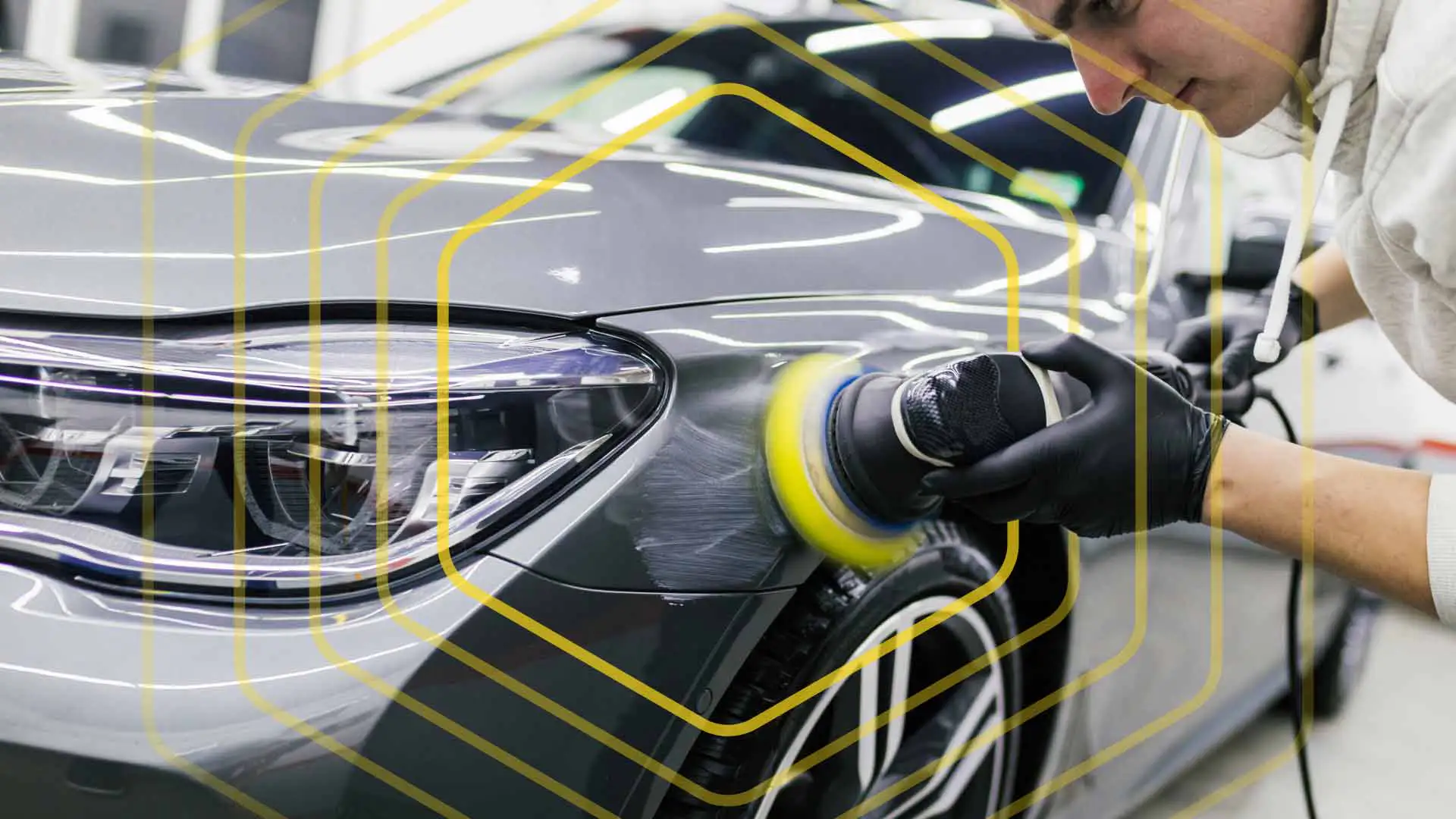 An auto detailer prepping a vehicle exterior for touch up painting.