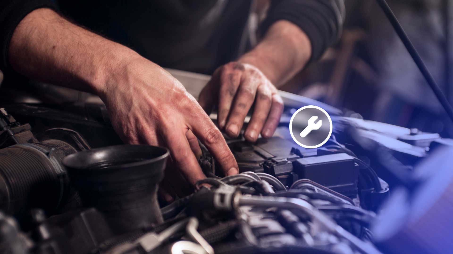 A mechanic cleaning carbon deposits from a vehicle engine.