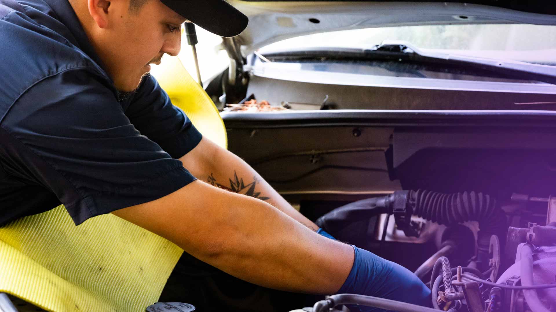 An auto technician working on a vehicle.