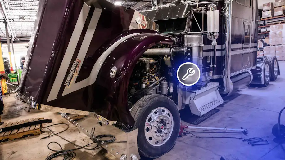 A truck that is being repaired in an auto shop.