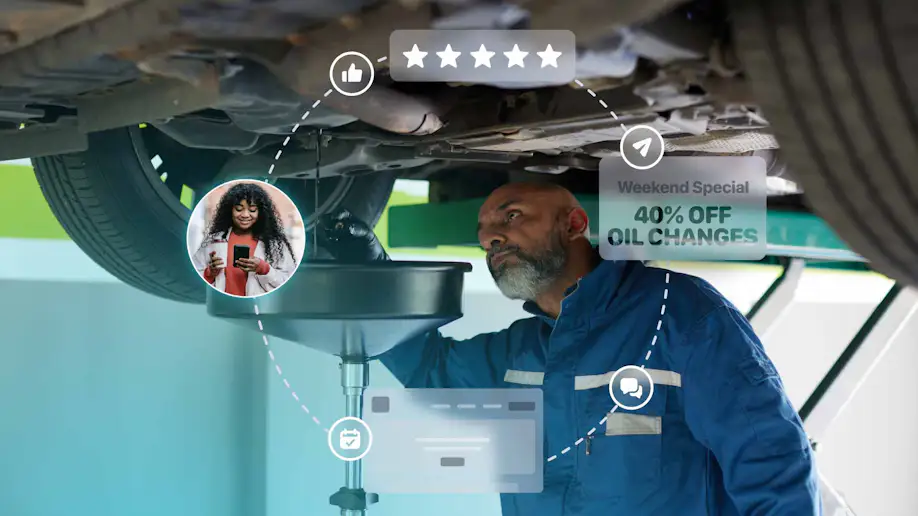 An auto shop owner working on a vehicle.