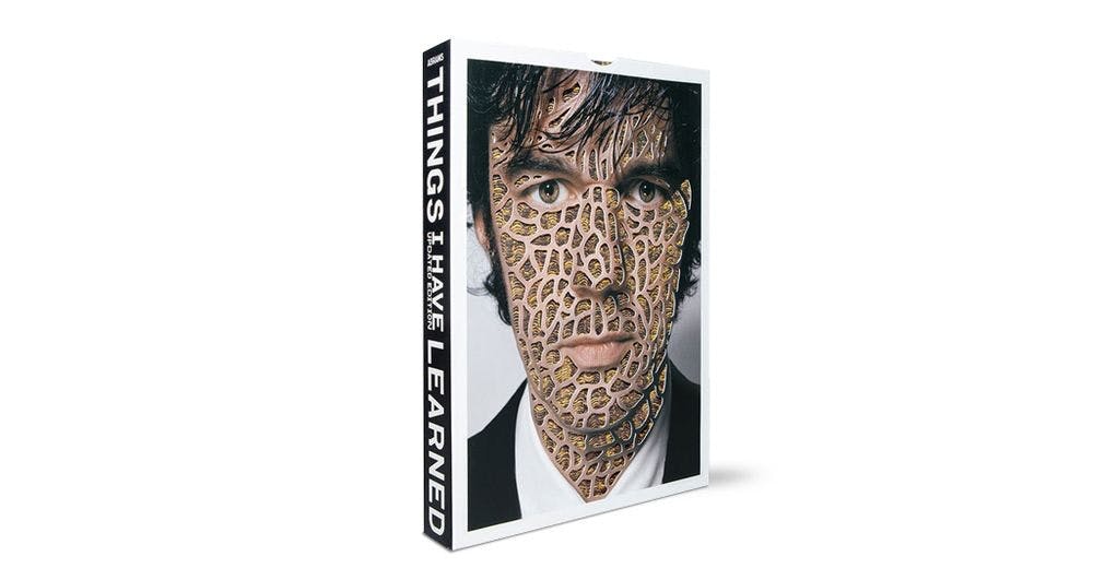 Book cover with man's face cover in giraffe-print-style tattoo