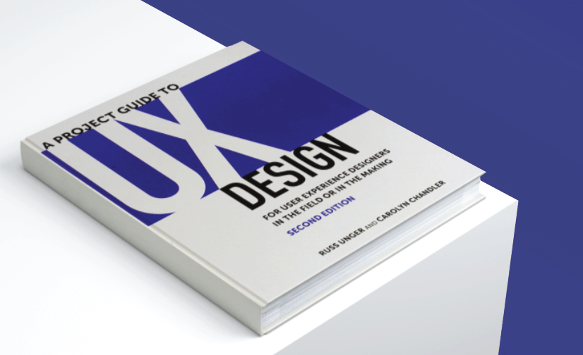 hardback book with white cover and half dark blue featuring large bold text saying UX design