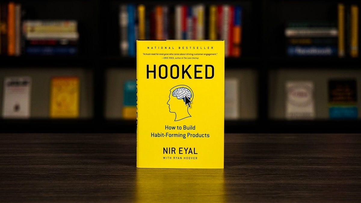 book with yellow cover and simple line illustration of a brain with large block letter reading HOOKED how to build habit-forming products