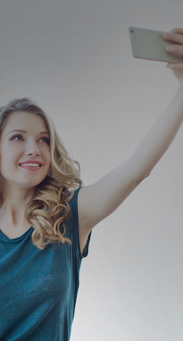 woman holding phone to take a selfie