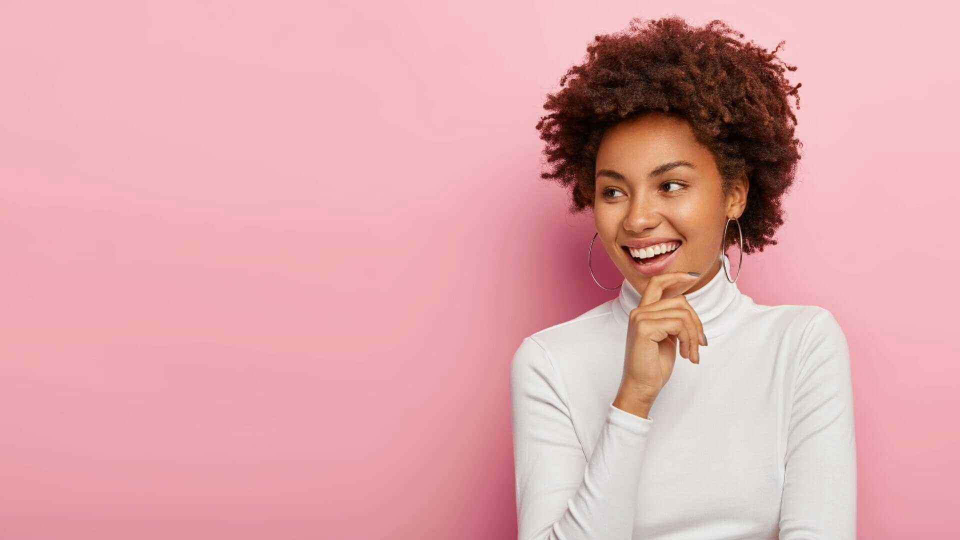 Smiling woman with her hand on her chin