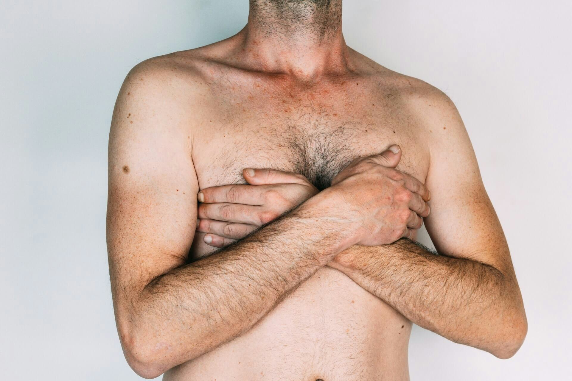 Man covering his chest with his hands