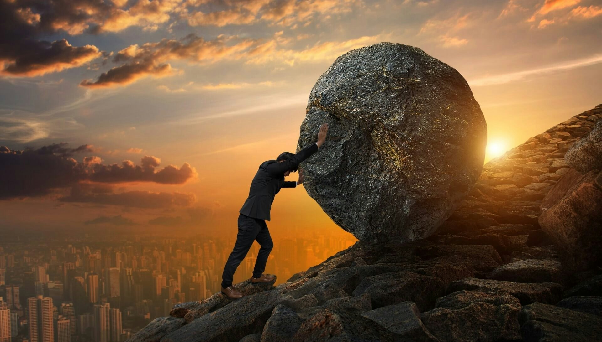 man holding a big rock
