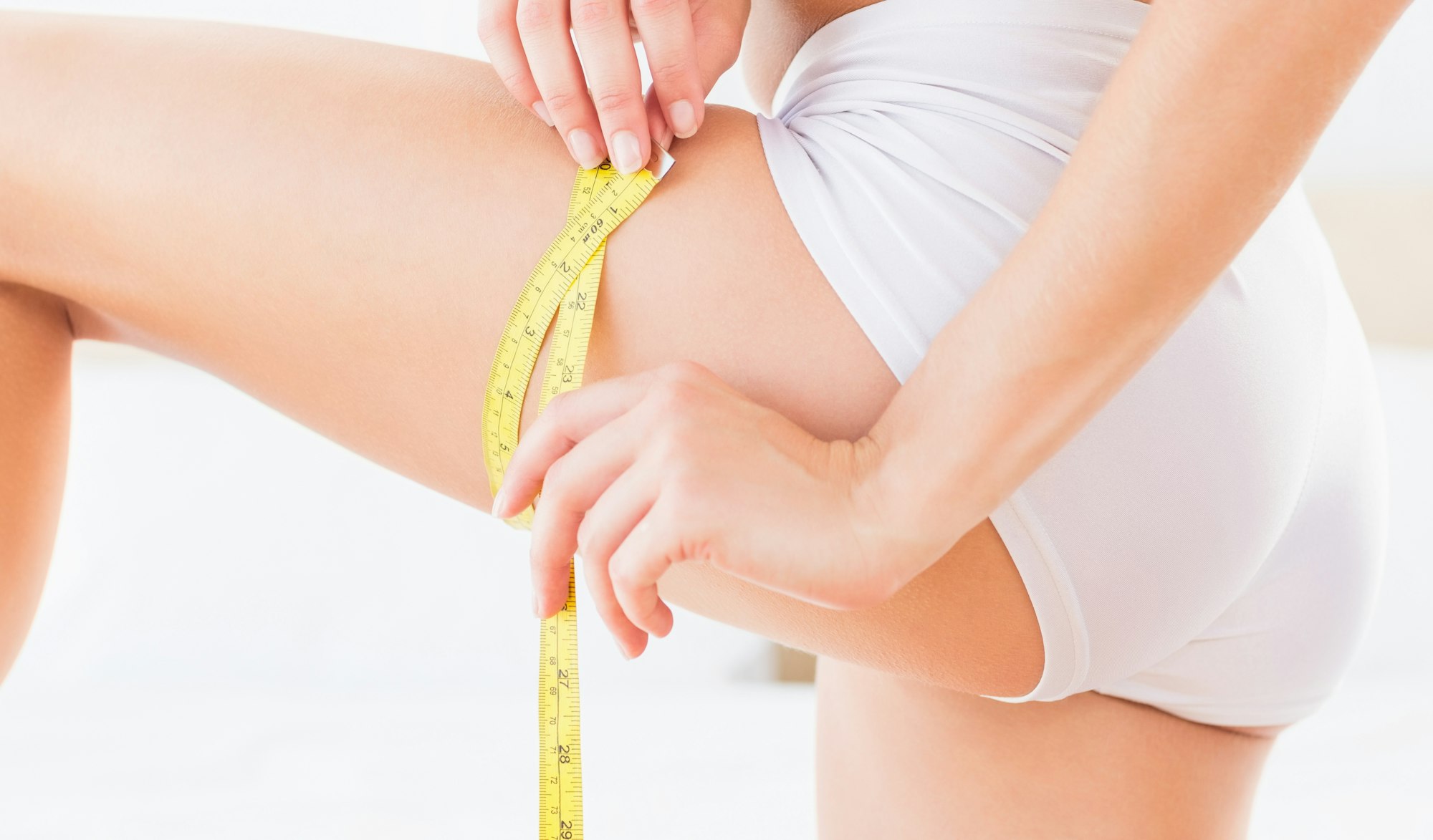 Woman measuring thigh