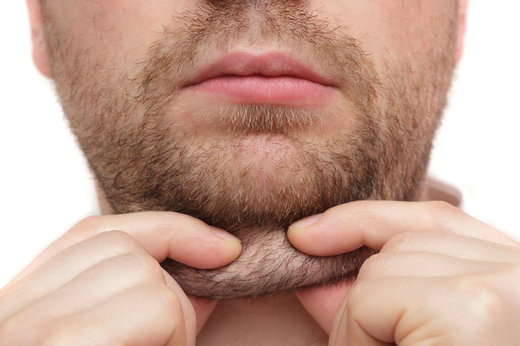 man with beard pinching neck fat