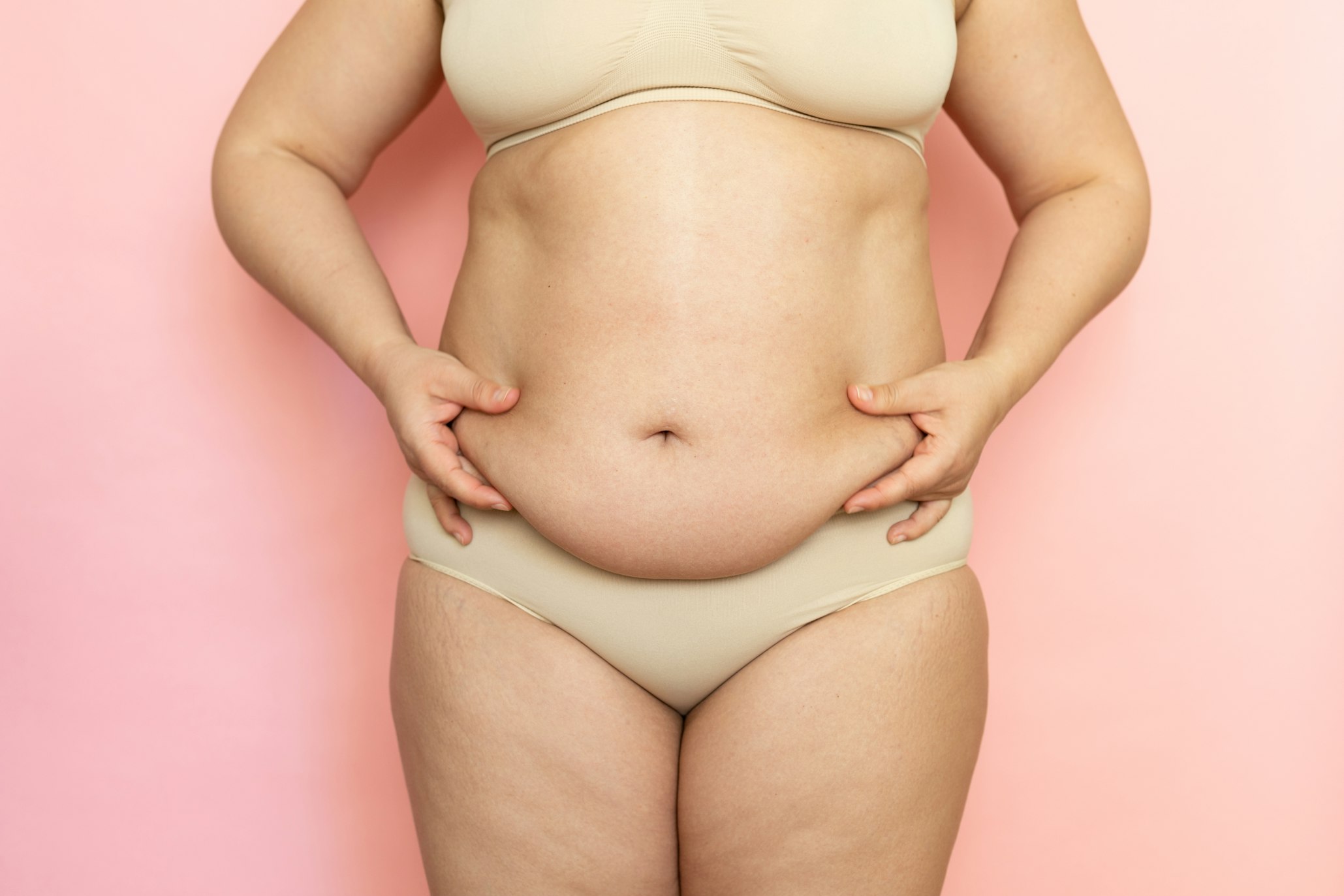 woman holding belly fat