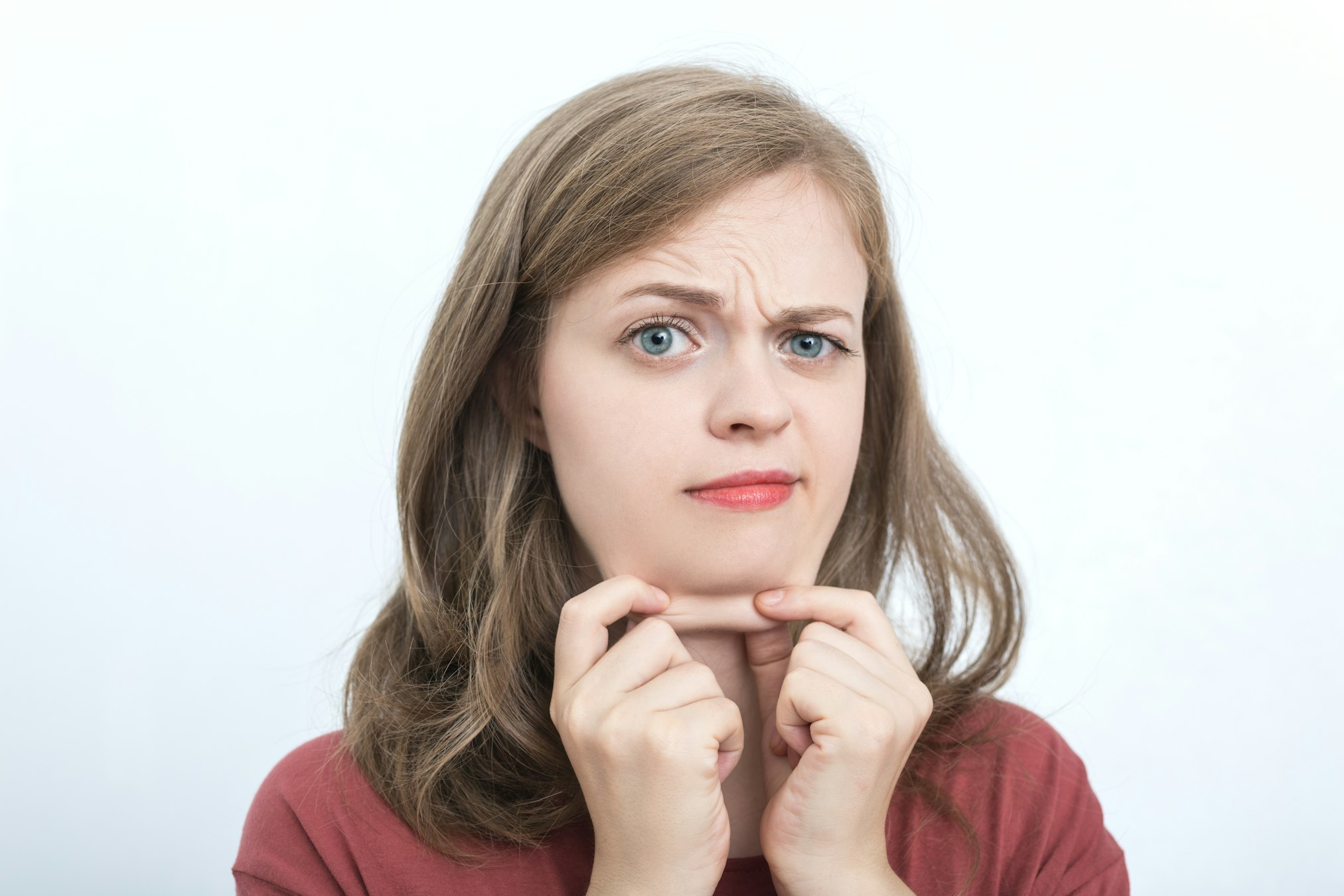 girl with double chin holding her flab