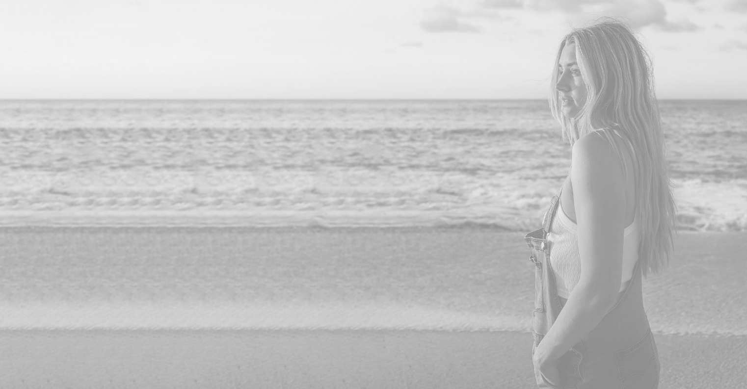 Woman staring out at ocean