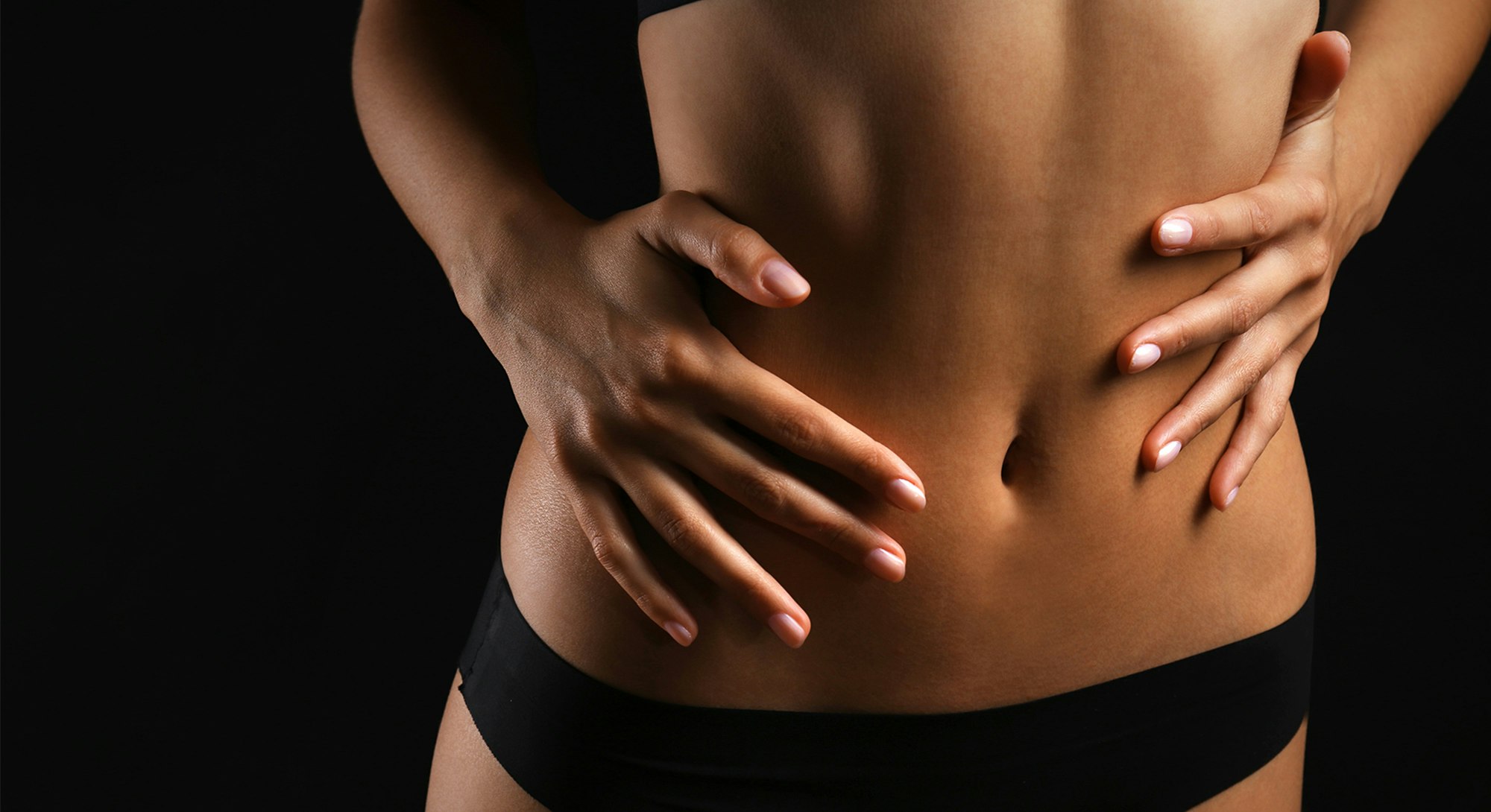 woman with hands on stomach