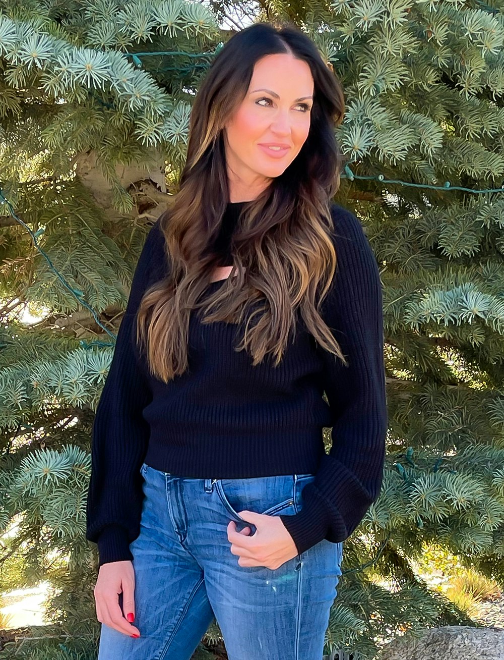 woman in jeans and black long sleeve
