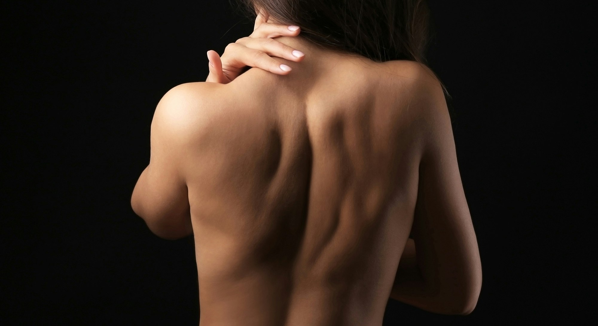 woman grabbing back of neck