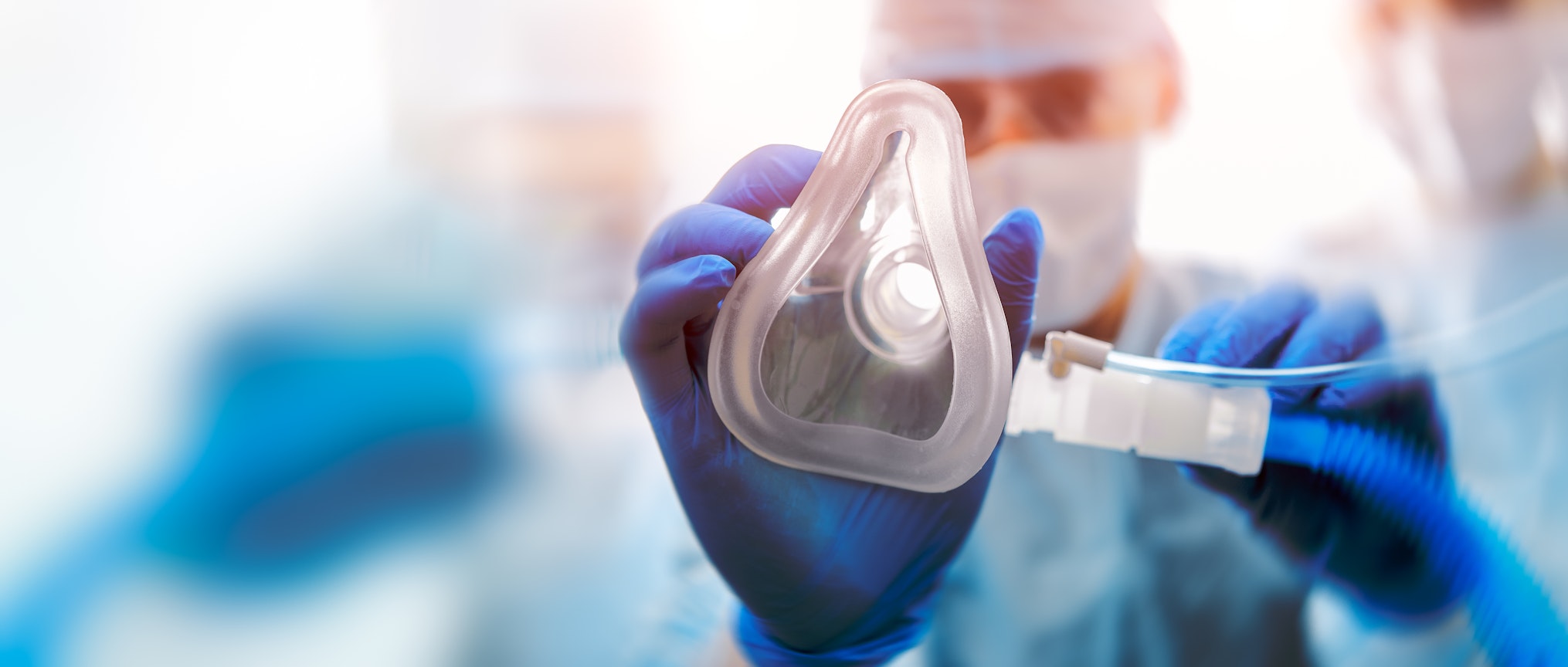 Doctor puts on oxygen mask. Emeregency and first aid concept.