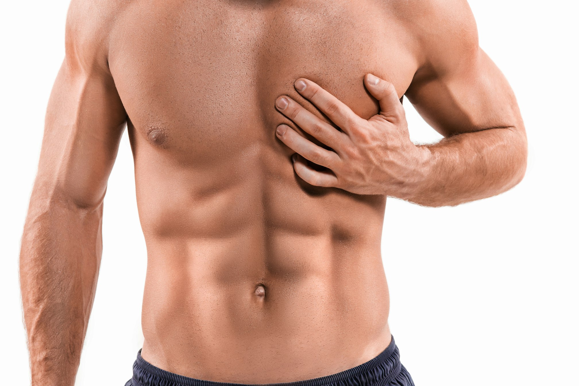 shirtless, muscular man covering one chest with hand
