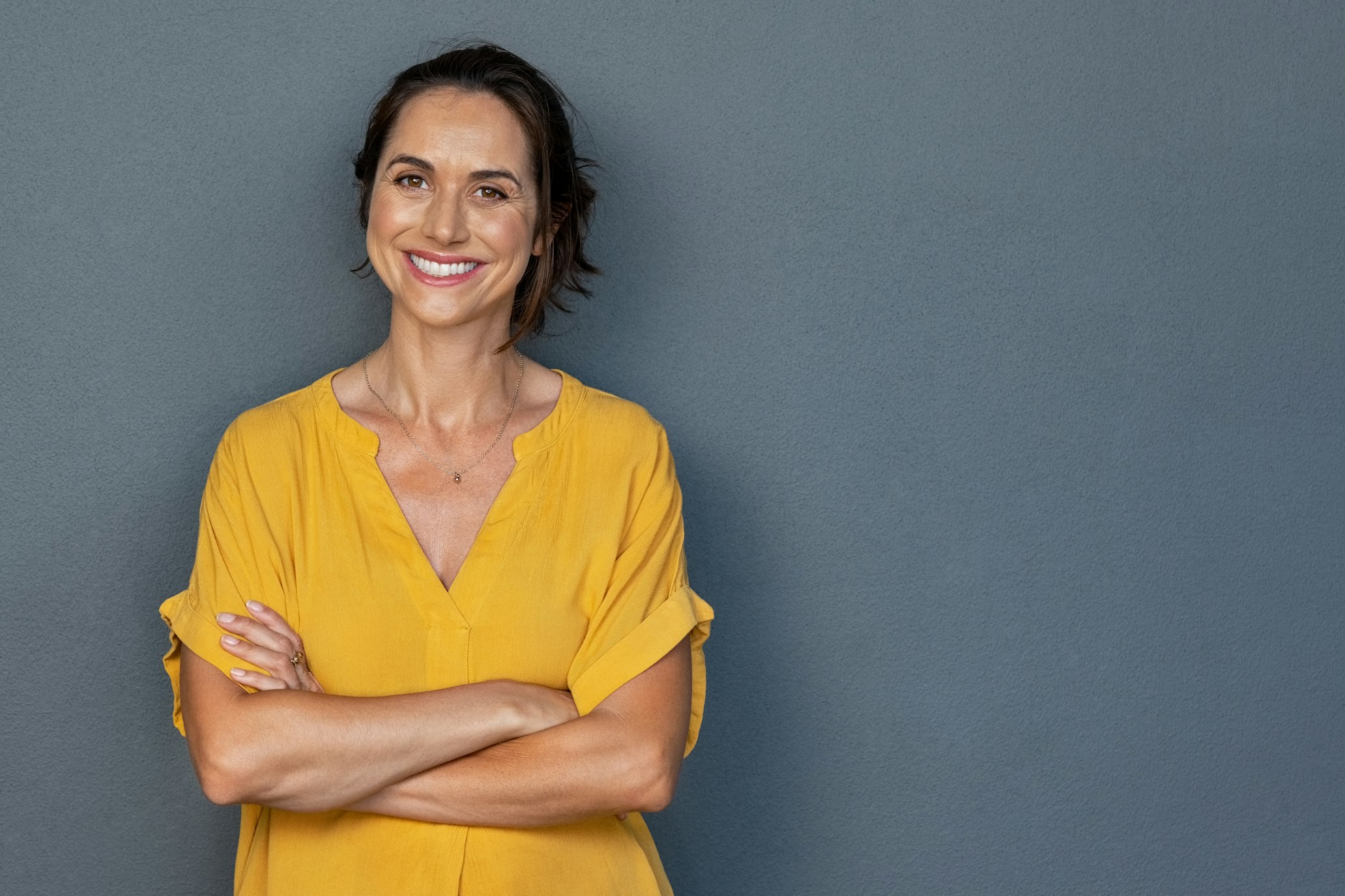 smiling woman in yellow shirt