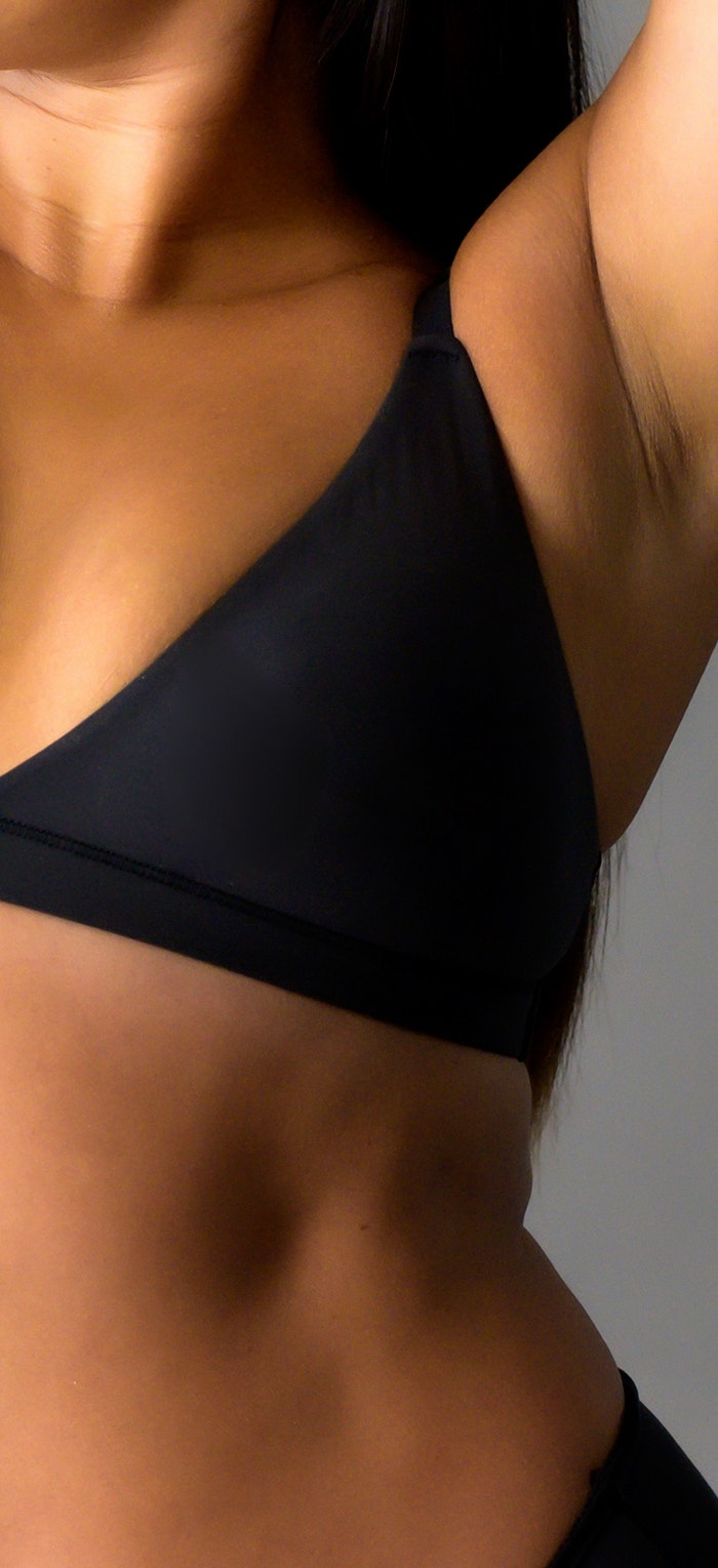 Woman in bra showing upper stomach