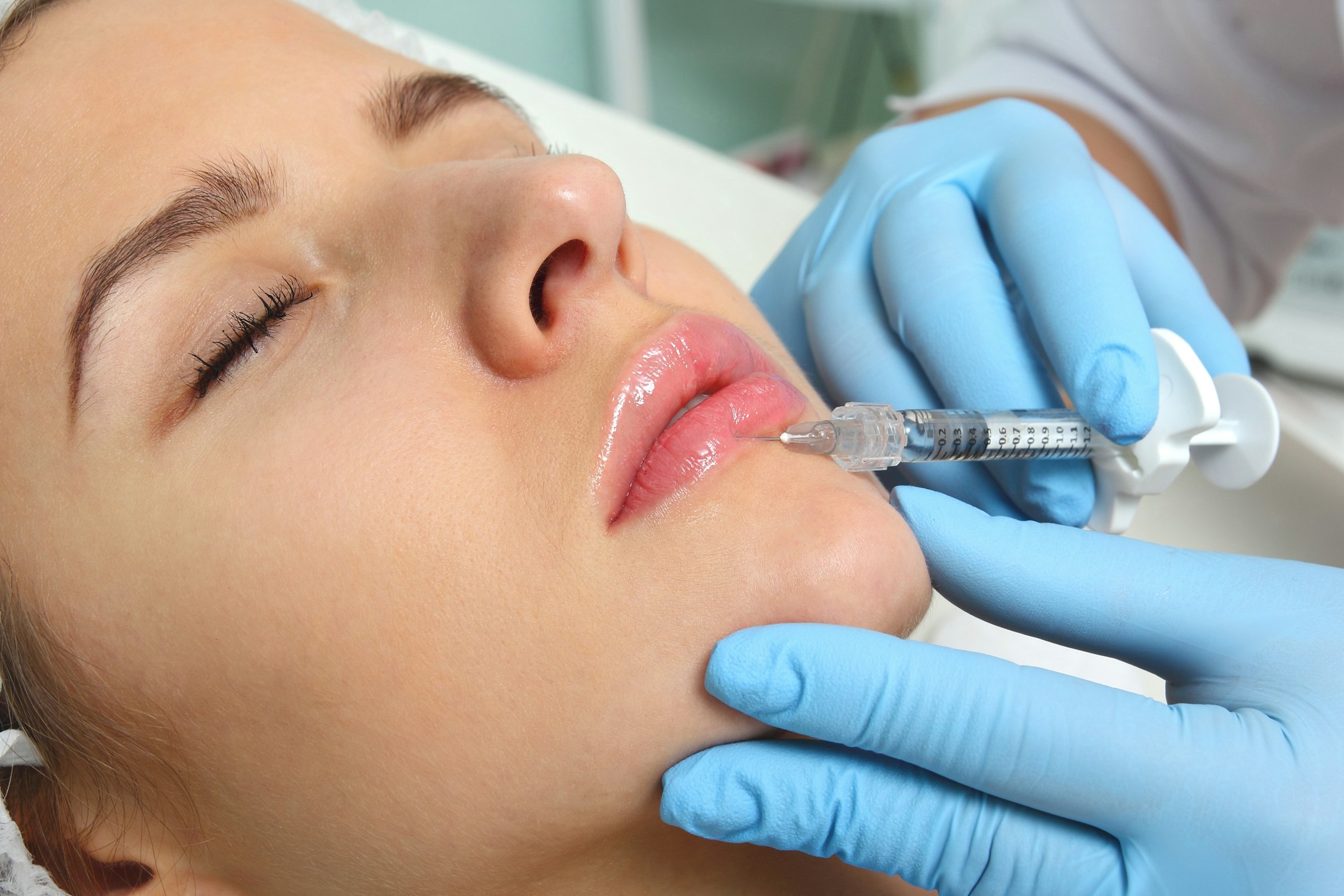 Beautiful woman gets an injection in her lips.