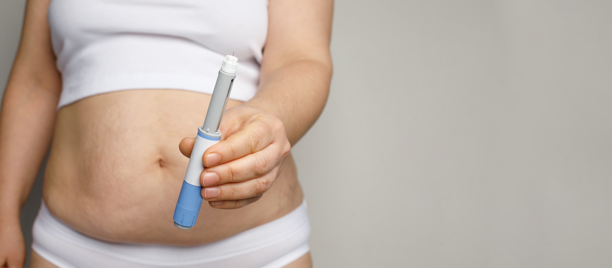 Semaglutide and weight loss concept. Woman showing Semaglutide Injection pen