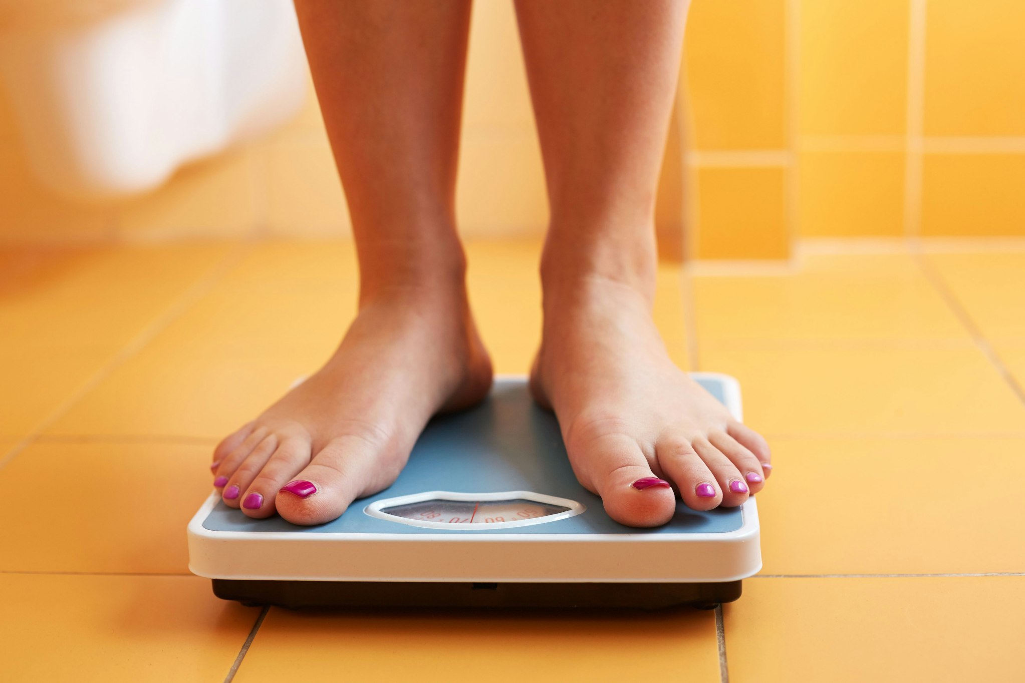 person on weight scale
