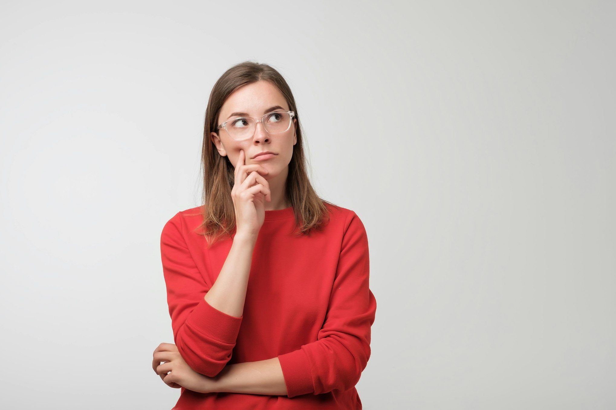 woman in red sweater pondering