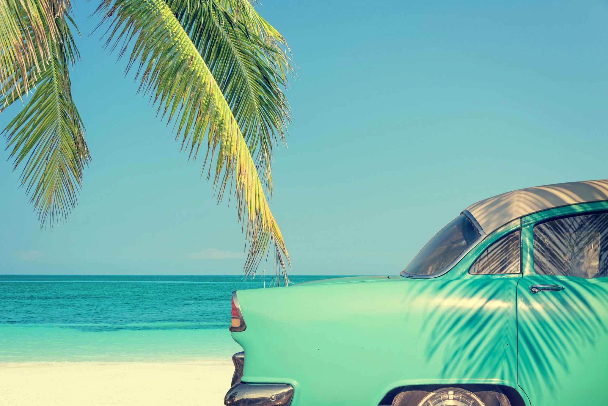 teal car at the beach