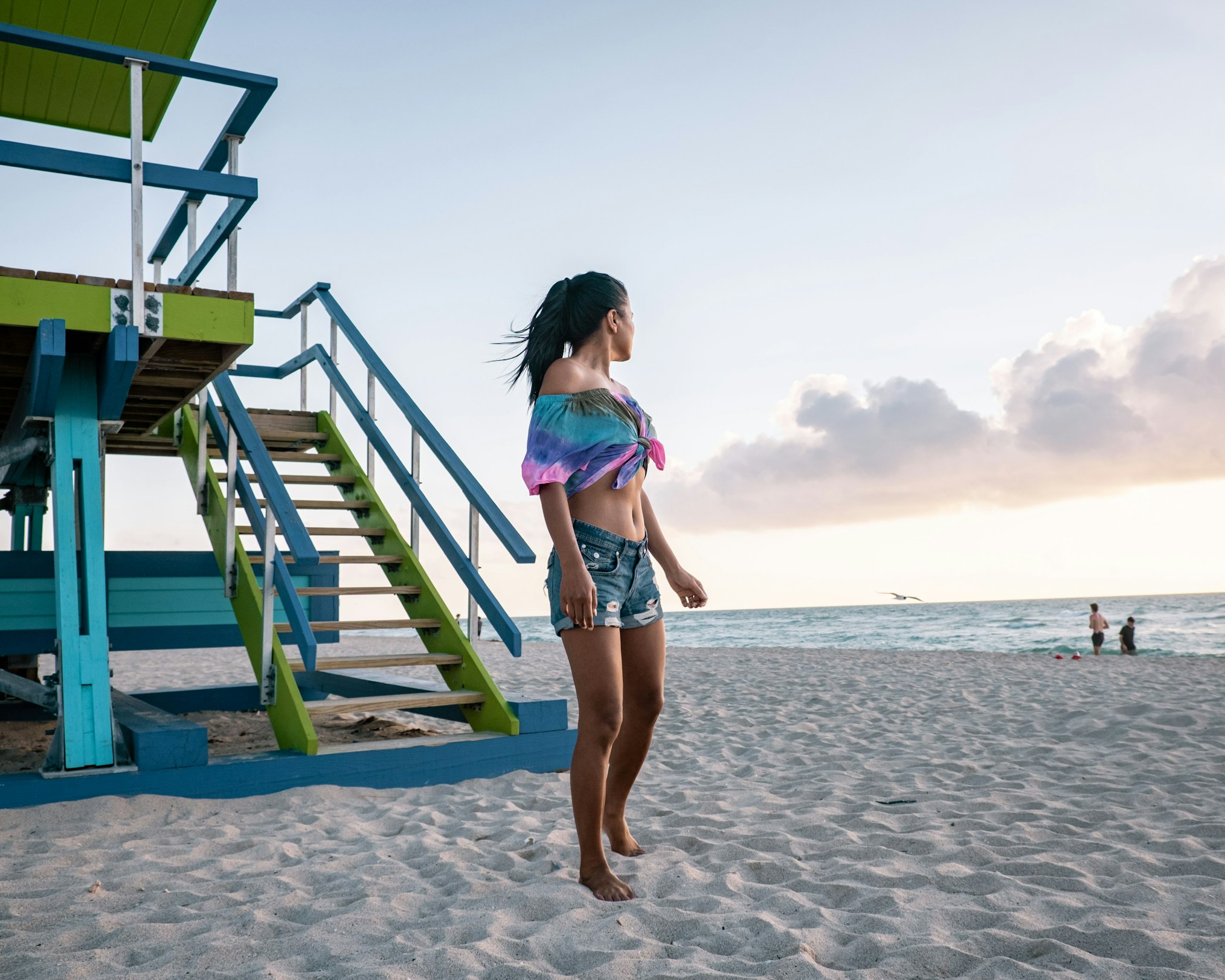 woman at the beach staring out to the water