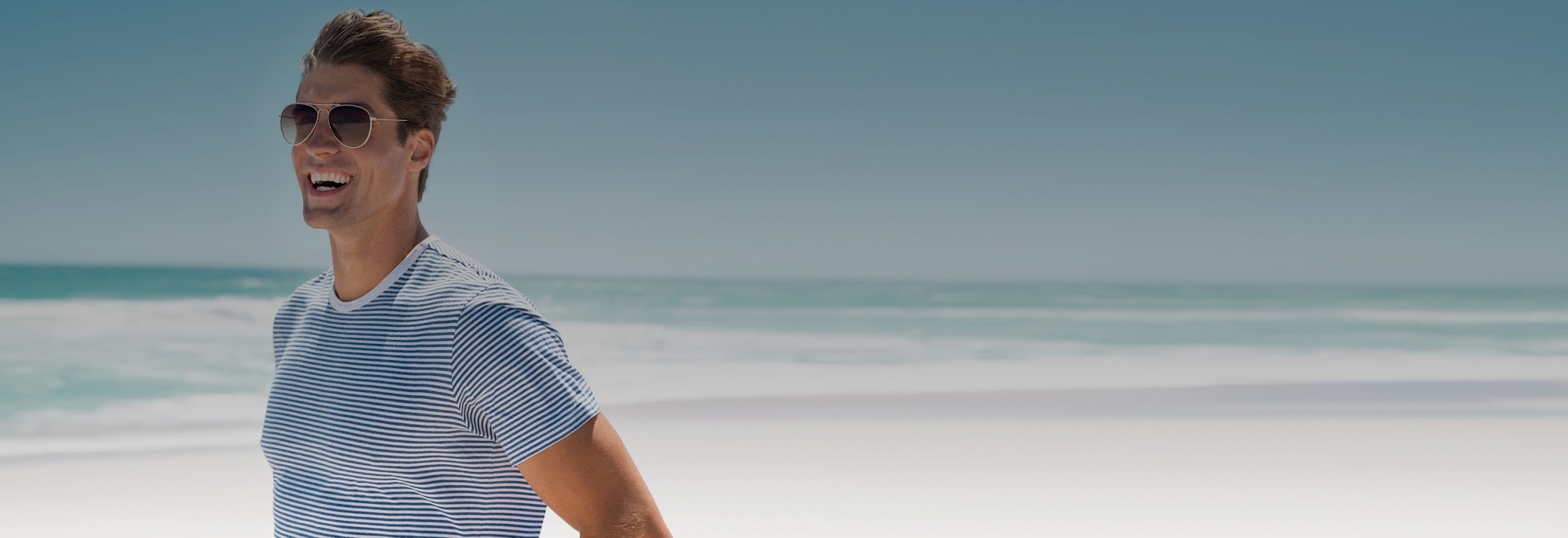 man smiling at the beach