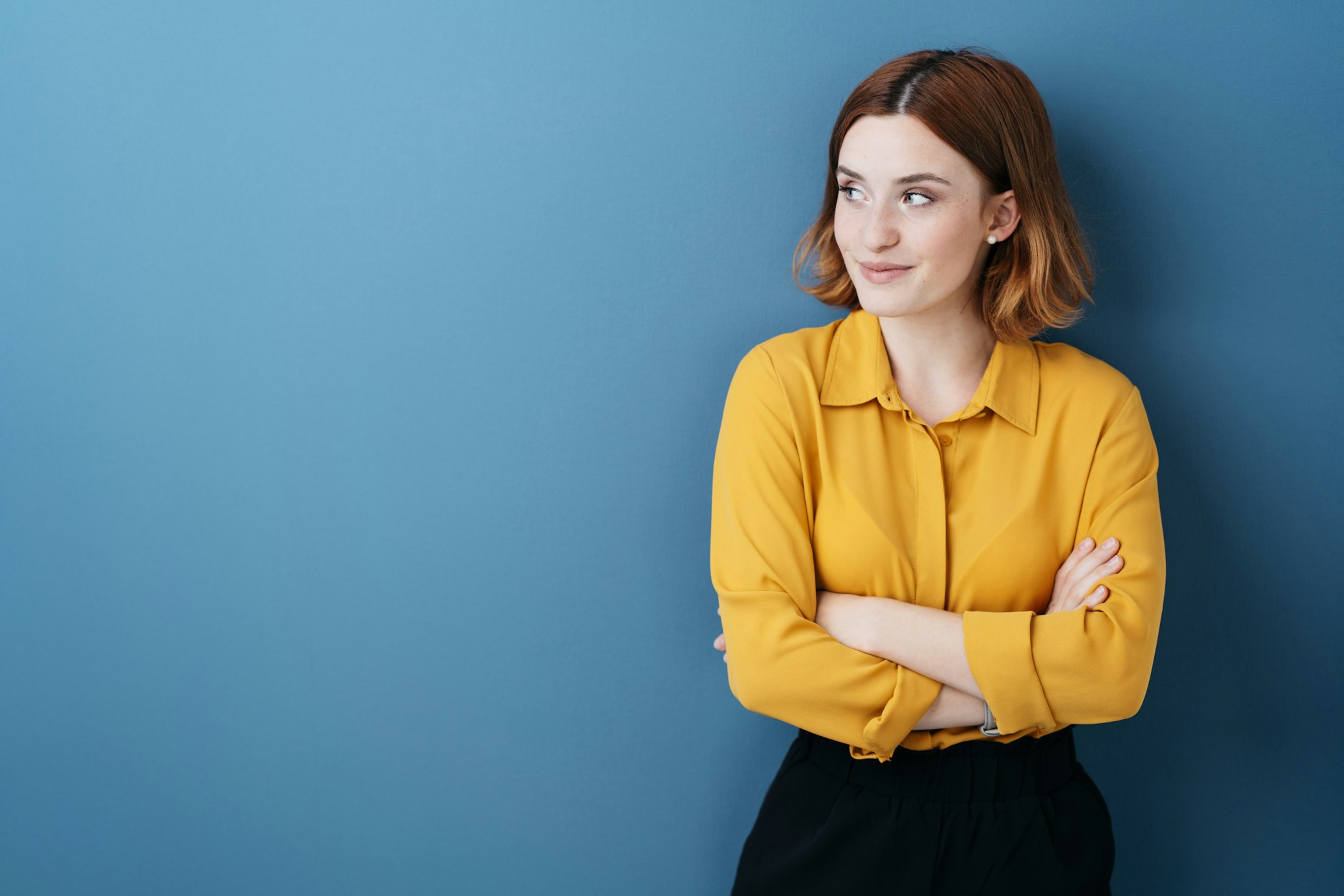 woman leaning on blue wall