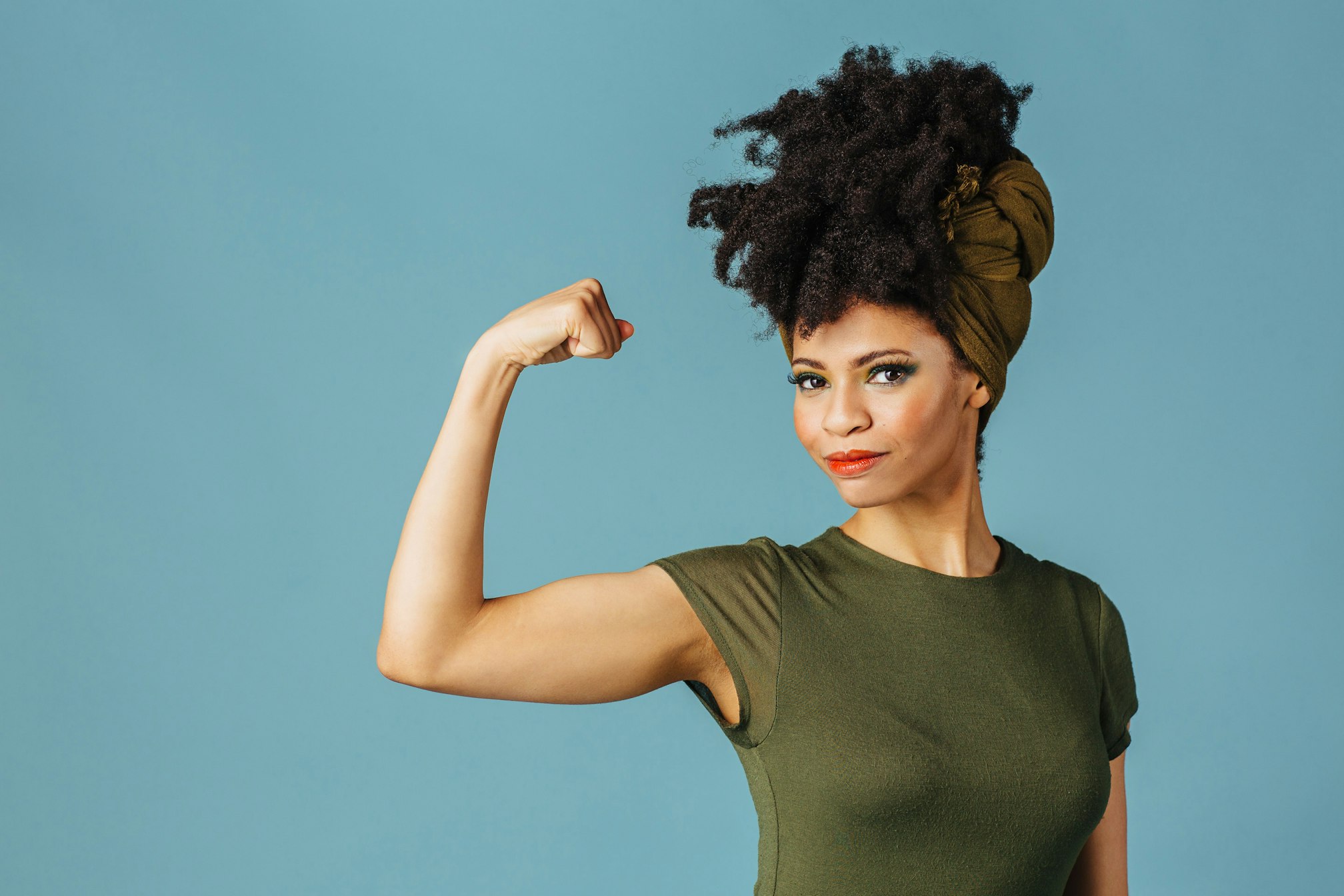 black woman flexing one arm