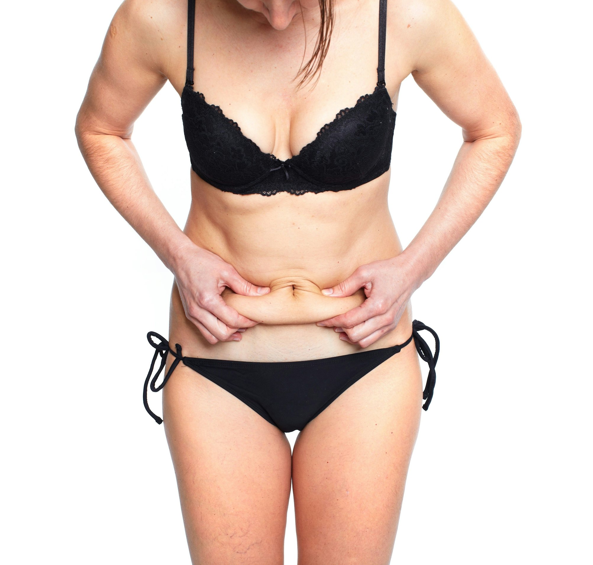 woman in black bikini grabbing stomach
