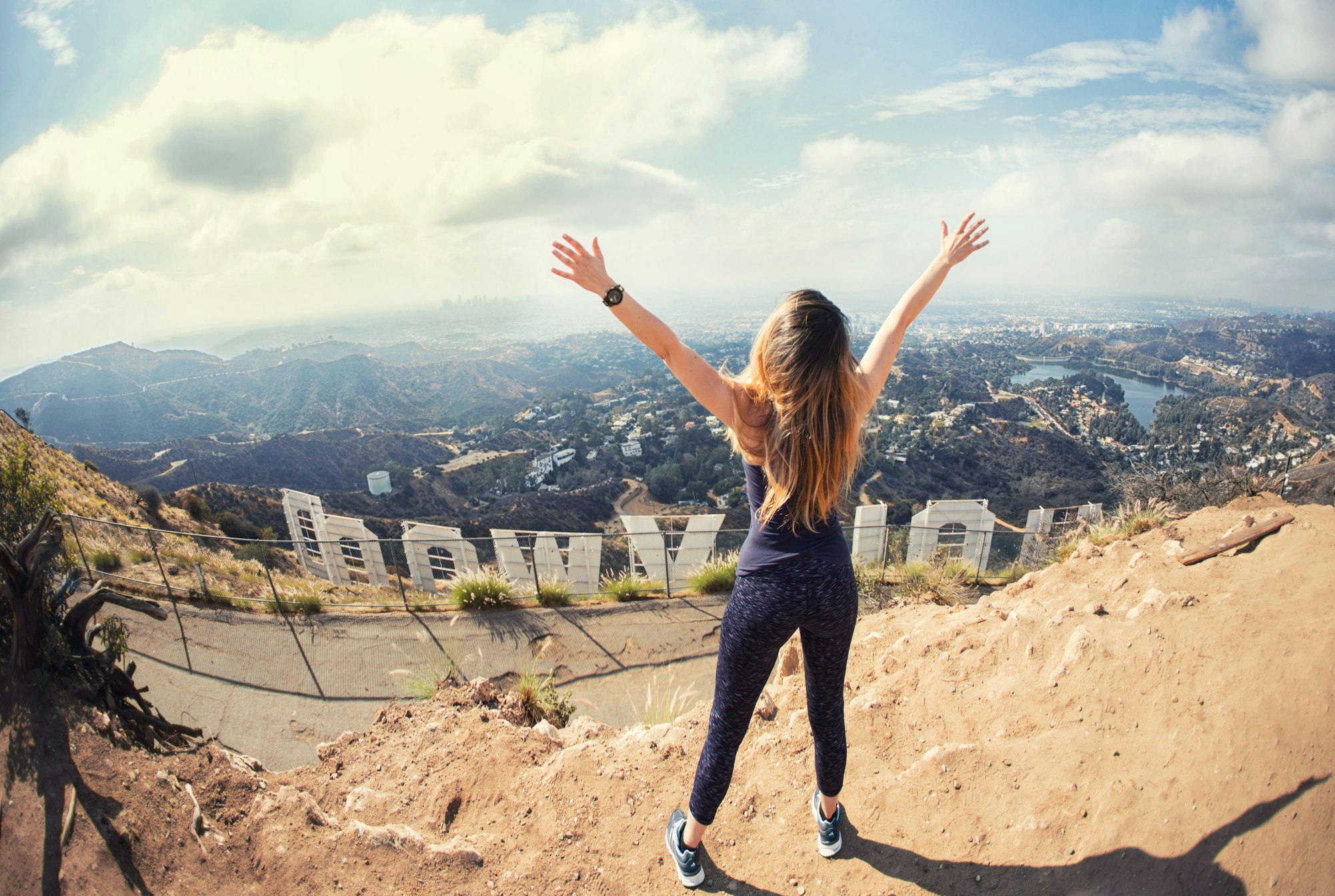 woman stretching out arms to LA