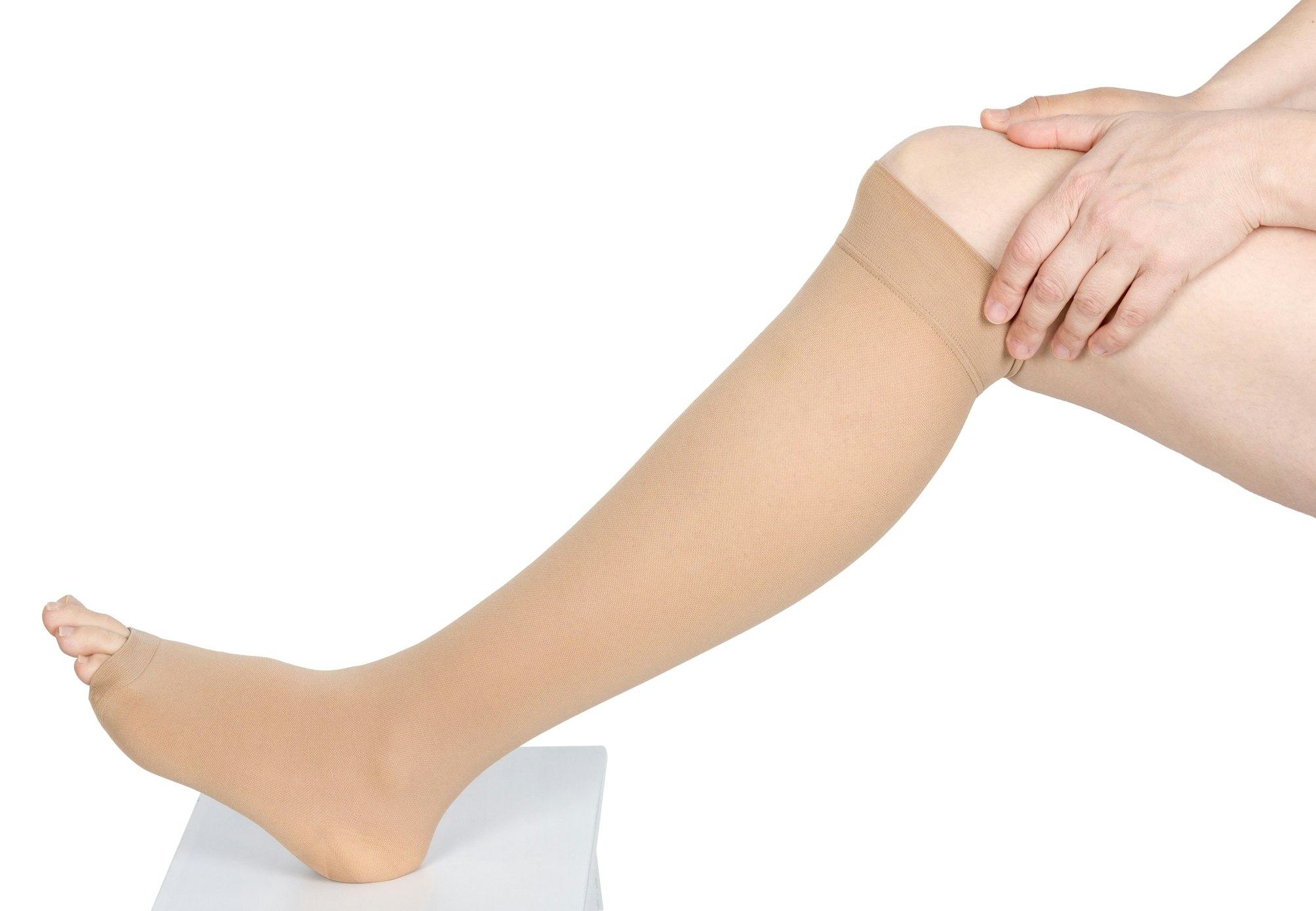 hands rubbing knee with compression garment