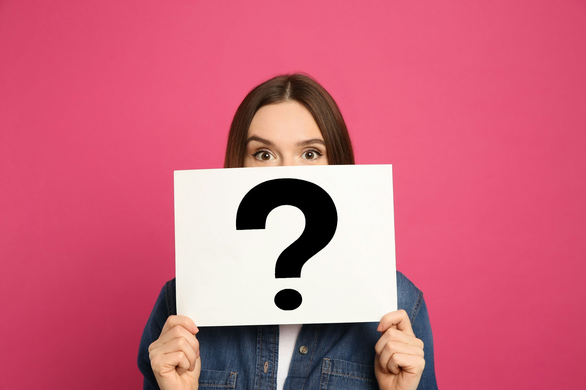 woman holding question mark sign